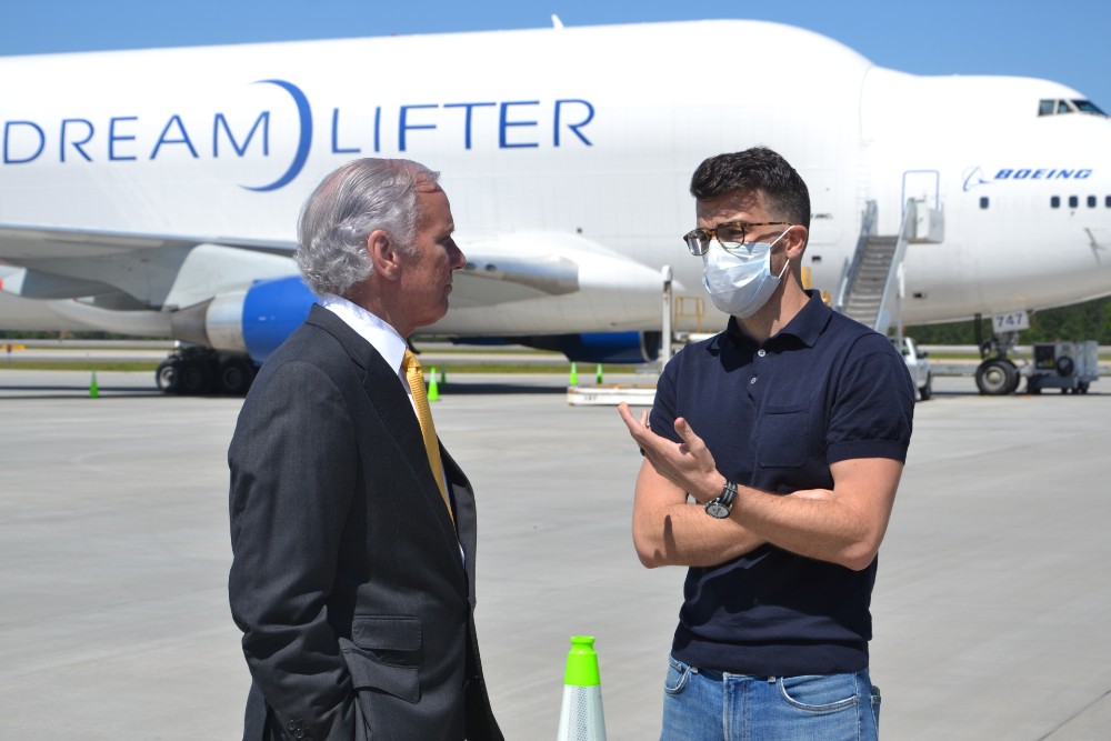 Discommon founder Neil Ferrier, right, talks with S.C. Gov. Henry McMaster as they wait for a Boeing Dreamlifter to touch down at GSP with personal protective equipment coming directly from China. (Photo/Ross Norton)