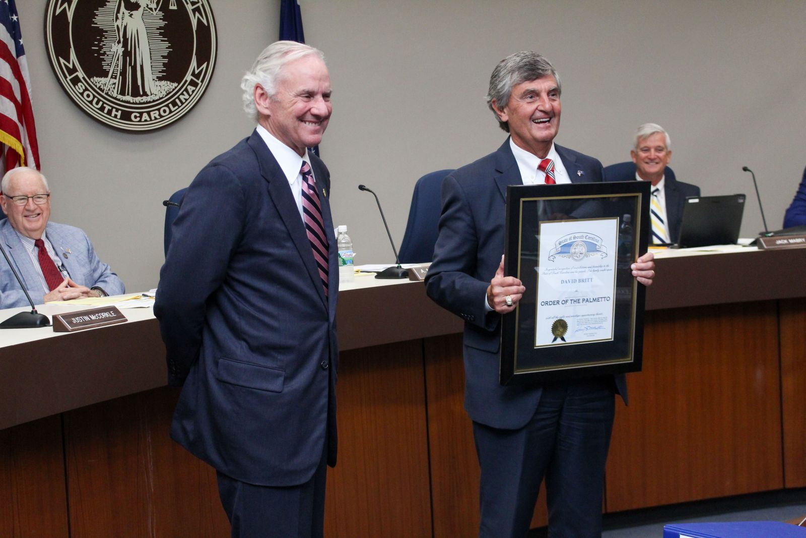  Gov. Henry McMaster presents David Britt with the Order of the Palmetto during a Spartanburg County Council meeting. Britt, vice president and general manager of Tindall Corp.'s South Carolina division, has served on the council since 1991. (Photo/Provided)