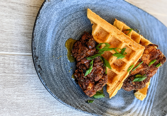Chicken and cornmeal waffles is one of The Village Kitchen's specialty dishes. (Photo/Provided)