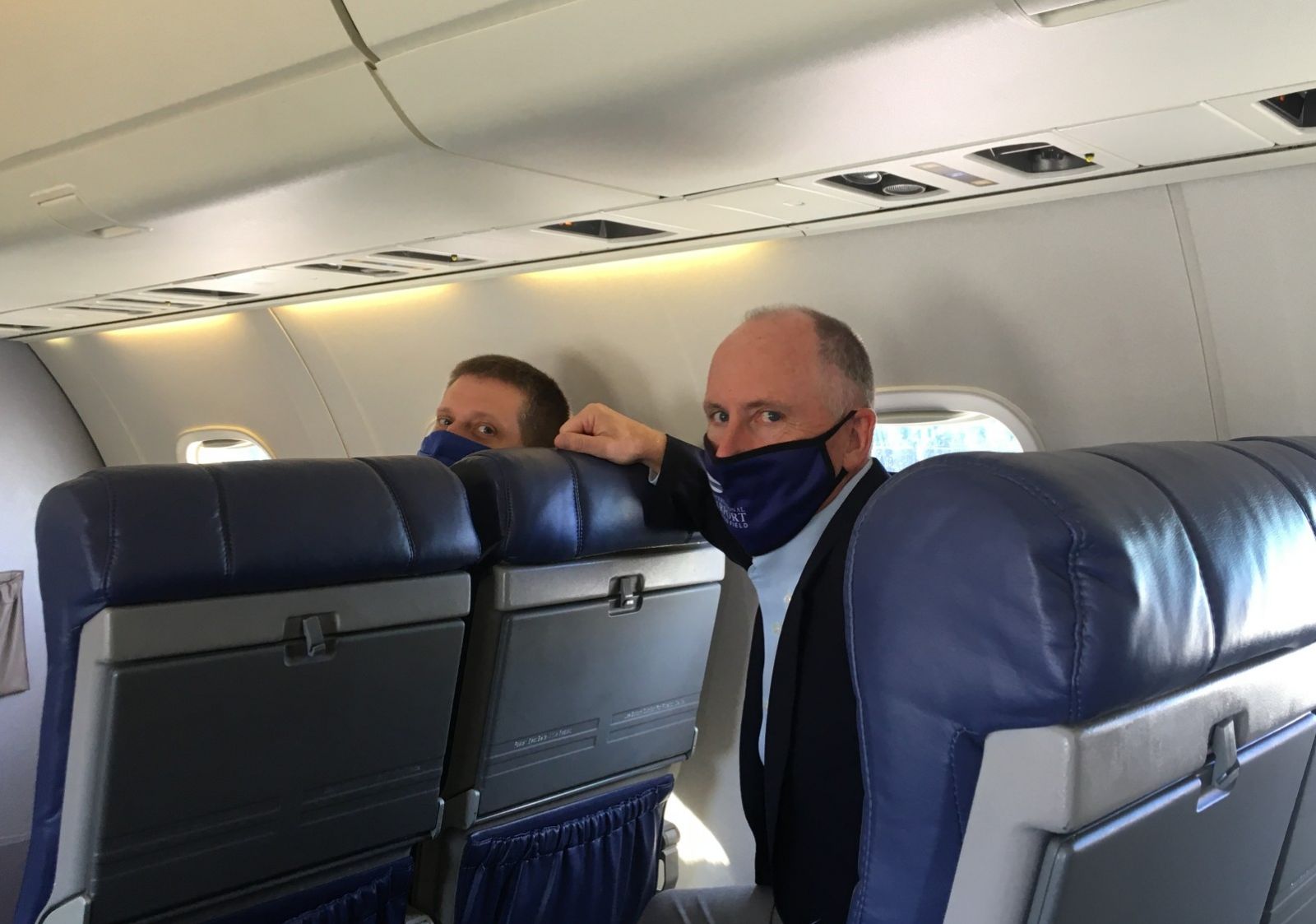 GSP CEO Dave Edwards and Scott Carr, vice president of commercial business and communications, try out the new seats on a tour of the Embraer jet. (Photo/Molly Hulsey) 