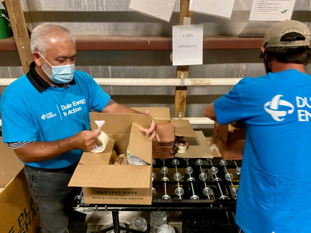 Duke employees volunteer their time to help pack food boxes. (Photo/Provided)