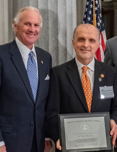 Gov. Henry McMaster and Clemson University Vice President for Research Tanju Karanfil pose for a photo at the South Carolina capitol.  (Photo/Provided)