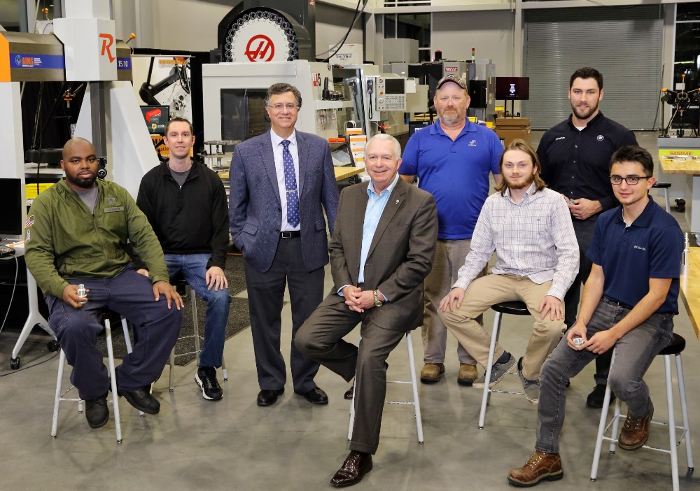 Students in Greenville Technical College's bachelor's in advanced manufacturing program include (from left) Christopher Scott, Shawn Hill, David Thacker, William Baker, Jonathan Devall and Vladislav Bondarchuk with (third from left) academic program director Philip M. Caruso and (fourth from left) Greenville Tech President Keith Miller at the Center for Manufacturing Innovation. (Photo/Provided)
