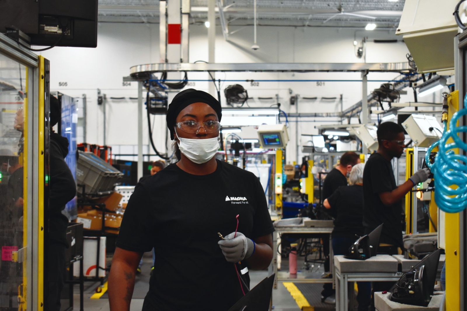 Employees at Magna Mirrors assemble mirrors for the automotive industry at an updated plant in Duncan, designed with a balance of automation and human talent in mind. (Photo/Molly Hulsey)