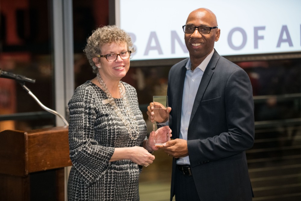Stacy Brandon, left, Bank of America's market president, presents Jerry Blassingame, executive director of Soteria Community Development Corp., with a memento of the organization's selection as the inaugural Neighborhood Champion for the Upstate. (Photo/Provided)