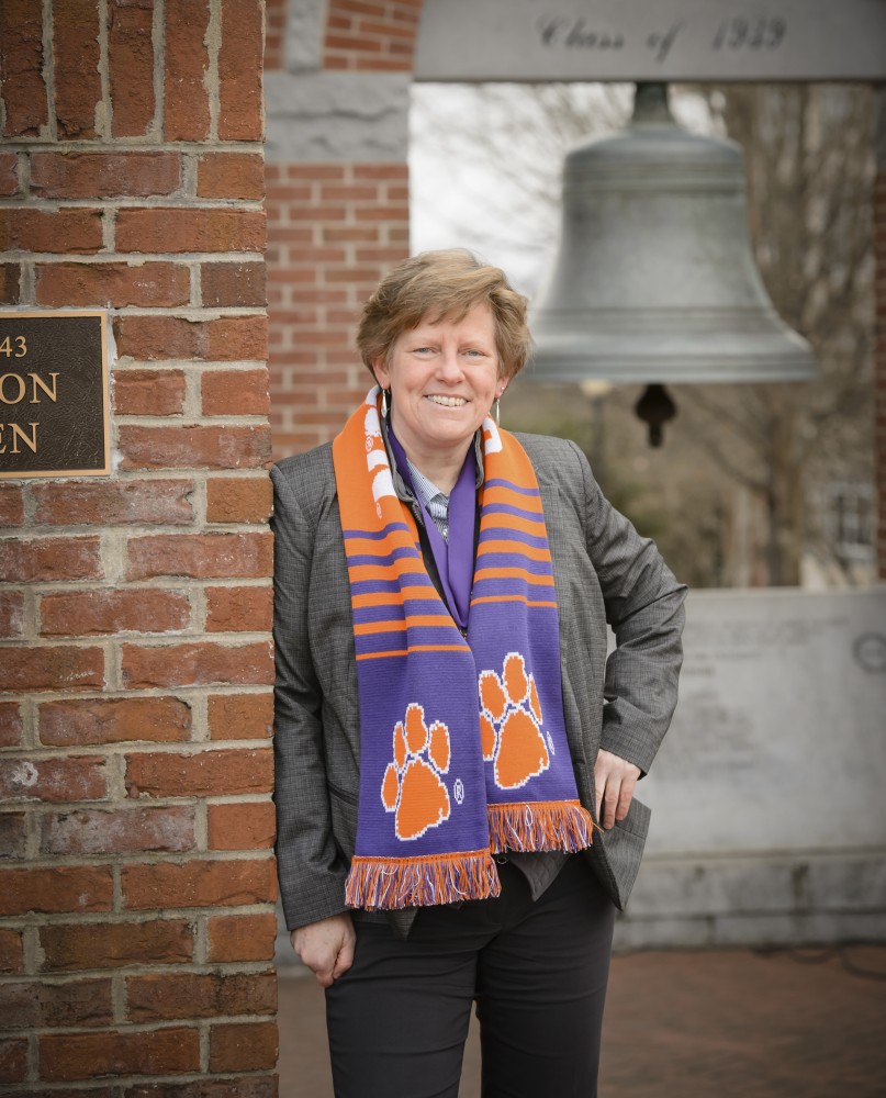 June Pilcher stands in front of the Class of '39 bell in Clemson's Carillon Garden. (Photo/Provided)