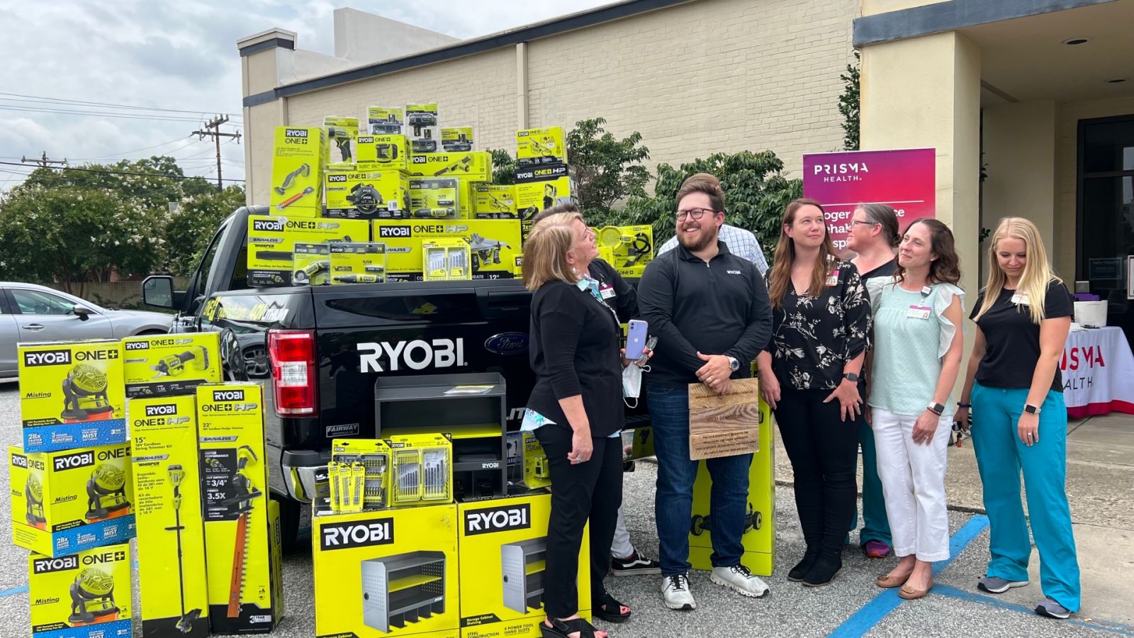 Ryobi Tool's Nico DiNunzio (in center with black shirt) is surrounded by Prisma Health's Roger C. Peace Rehabilitation Hospital staff as they receive $4,000-worth of Ryobi tools. (Photo/Provided)
