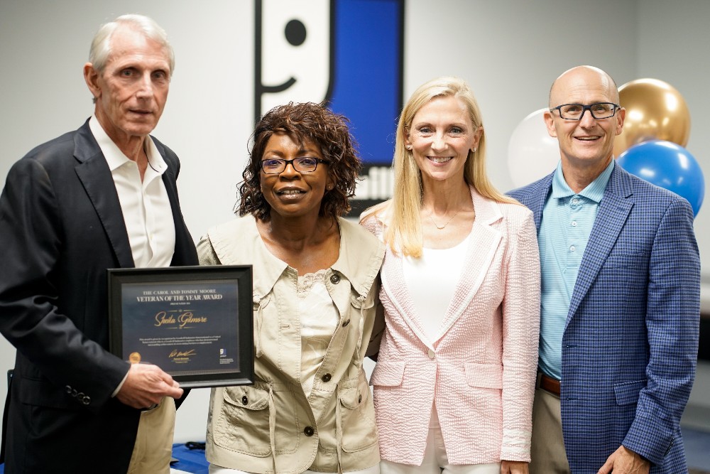 Tommy and Carol Moore present  Sheila Gilmore with the award honoring her as Goodwill's International Veteran of the Year. Also pictured is  Pat Michaels, president andCEO, Goodwill Industries of Upstate/Midlands SC. (Photo/Jarid Munsch)