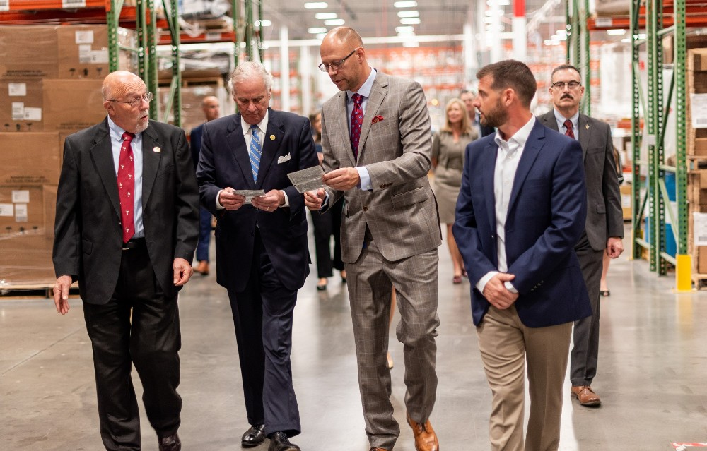 Gov. Henry McMaster, second from left, examines surface disinfectant wipes manufactured at Multi-Pack Solutions in Greenville. Company CEO John Niemi, center, and Ryan Strange, director of operations, right, led the governor on a tour of the medical contract manufacturers' facilities and discussed plans for expansion. They were joined by Lynn Ballard, left, a member of Greenville County Council. (Photo/Provided)
