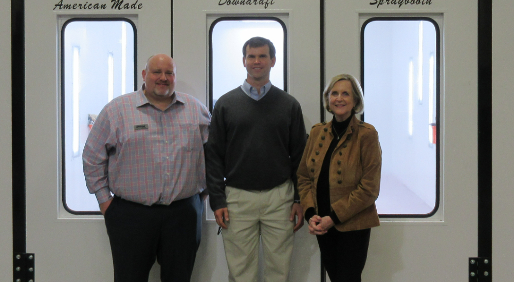 Daniel Campbell and Foster McKissick of Fairway Automotive Group and Elizabeth Clayton of John I. Smith Charities pose with one of the new paint booths their gifts afforded the auto body repair program at Greenville Technical College. (Photo/Provided)