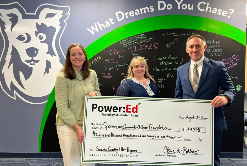Power:Ed Executive Director Claire Gibbons (center) presents Spartanburg Community College Executive Director of Advancement John Jaraczewski (right) and Dean of Student Success Witney Fisher (left) with a check for funds to support the establishment of a Student Success Coach. (Photo/Provided)
