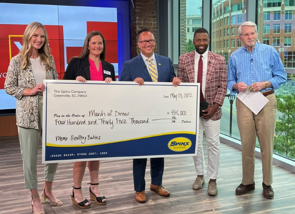 Katie Peden and Laura Goodwin (from left) with the March of Dimes accept a check from Stan Storti, The Spinx Co., at the WSPA studios, with Jamarcus Gaston and Jack Roper of WSPA. (Photo/Provided)