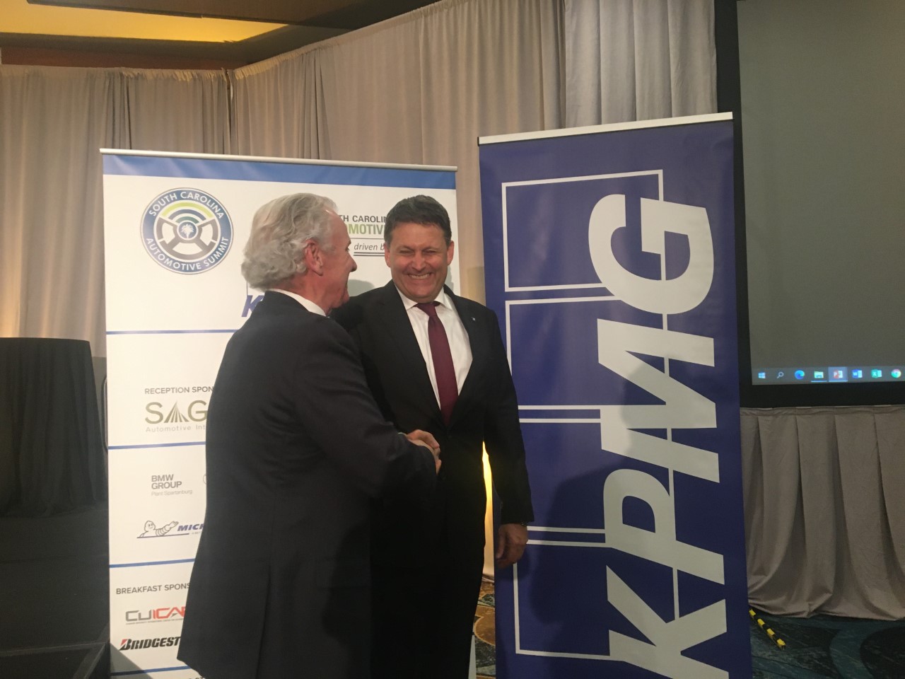 Gov. Henry McMaster shakes hands with Robert Englehorn at the S.C. Automotive Summit after the announcement. (Photo/Molly Hulsey)