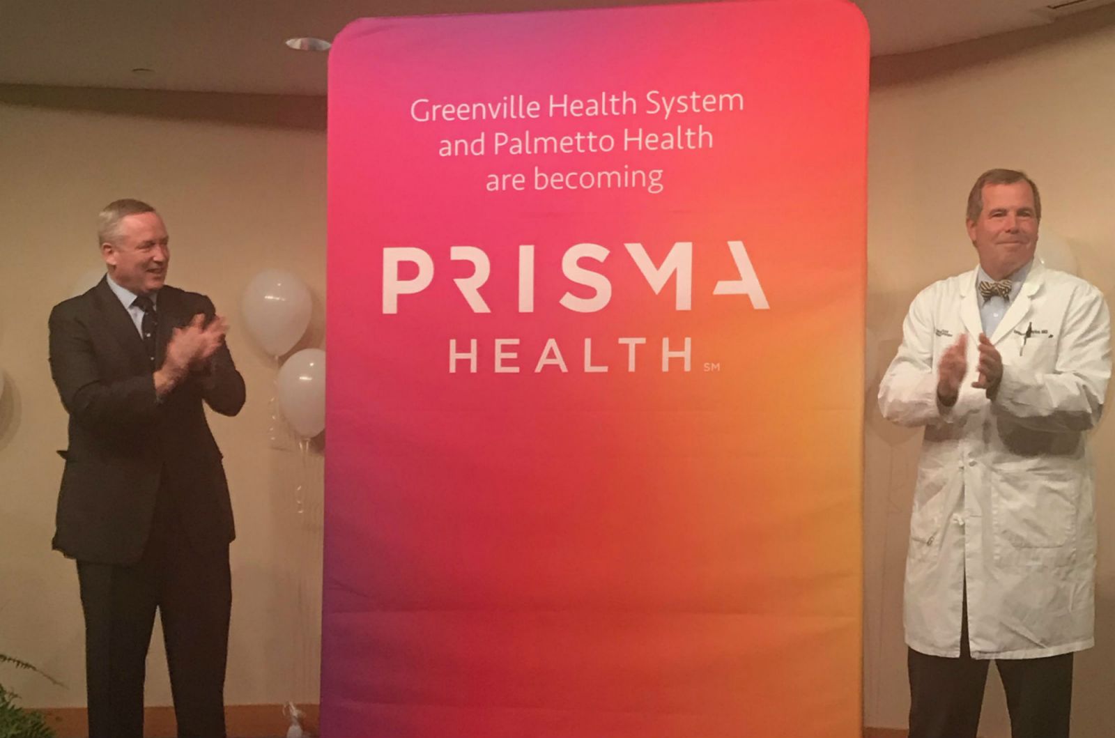Prisma Health co-CEO Michael Riordan, left, and Dr. Spence Taylor, president of the Upstate affiliate of Prisma Health, unveil the company's new logo. (Photo/Teresa Cutlip)