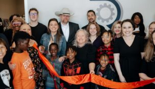 Staff members and their families celebrate the opening of the first official office for R&R Resolute Staffing Firm on Old Buncombe Road in Greenville. (Photo/R&R Resolute Staffing Firm)